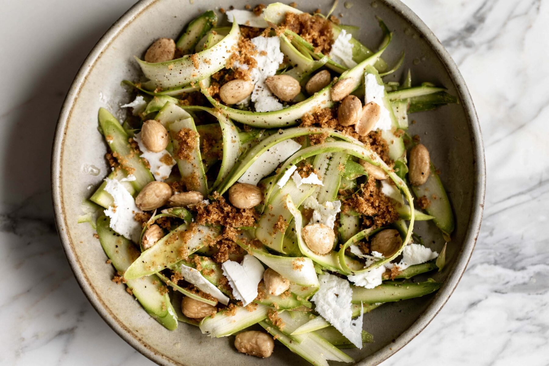 shaved asparagus salad with marcona almonds, shaved ricotta salata and breadcrumbs.
