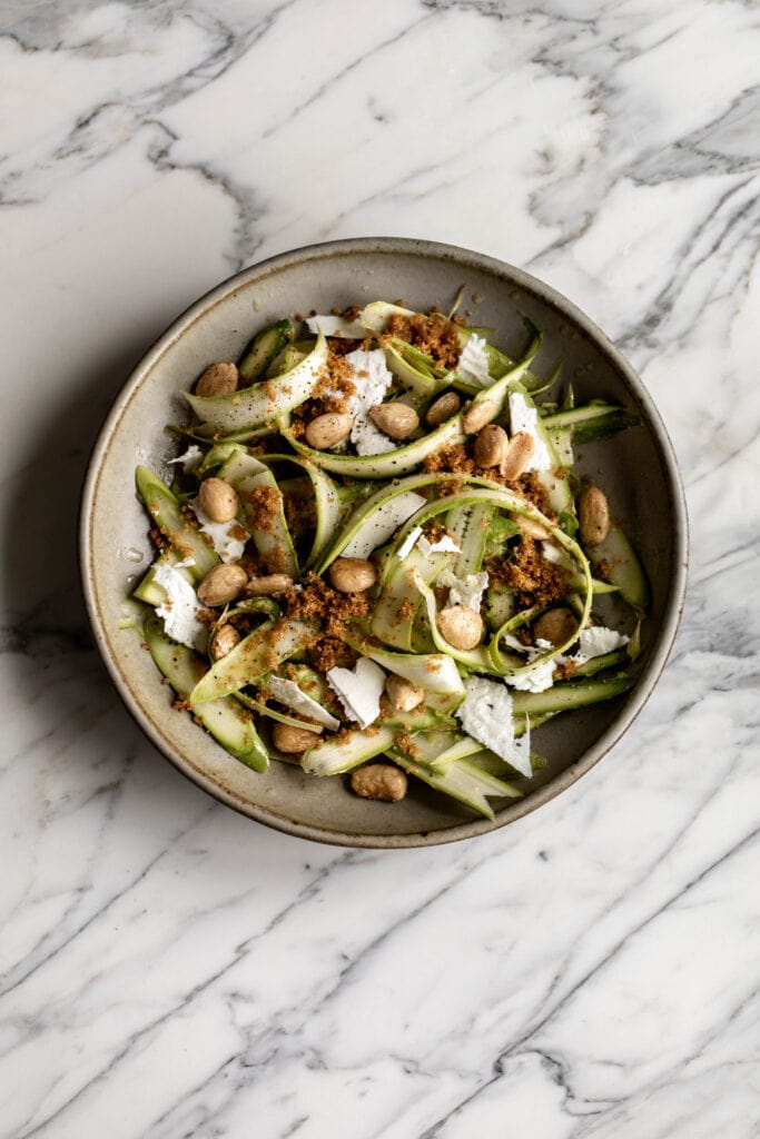 shaved asparagus salad with marcona almonds, shaved ricotta salata and breadcrumbs.