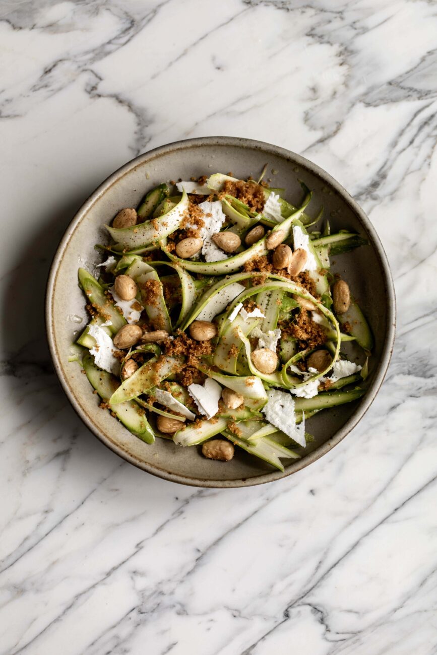 shaved asparagus salad with marcona almonds, shaved ricotta salata and breadcrumbs.