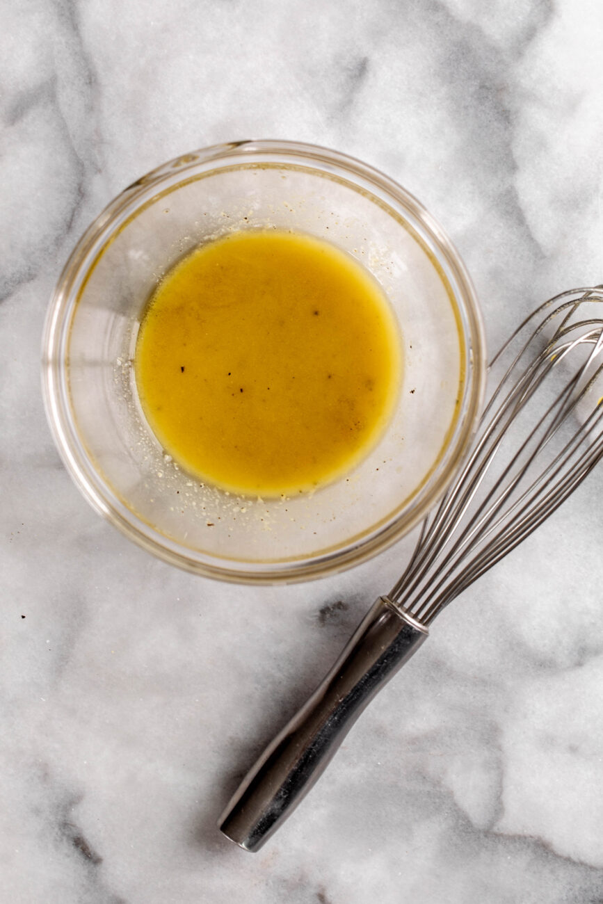 whisked dressing in glass bowl.