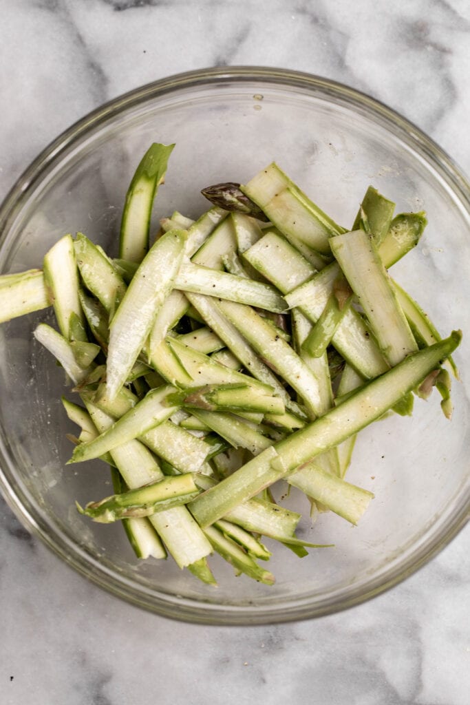 raw shaved asparagus tossed with dressing.