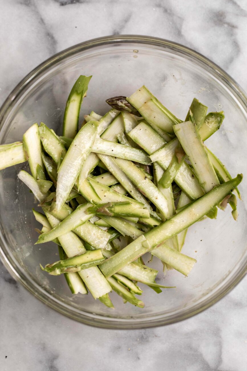 raw shaved asparagus tossed with dressing.