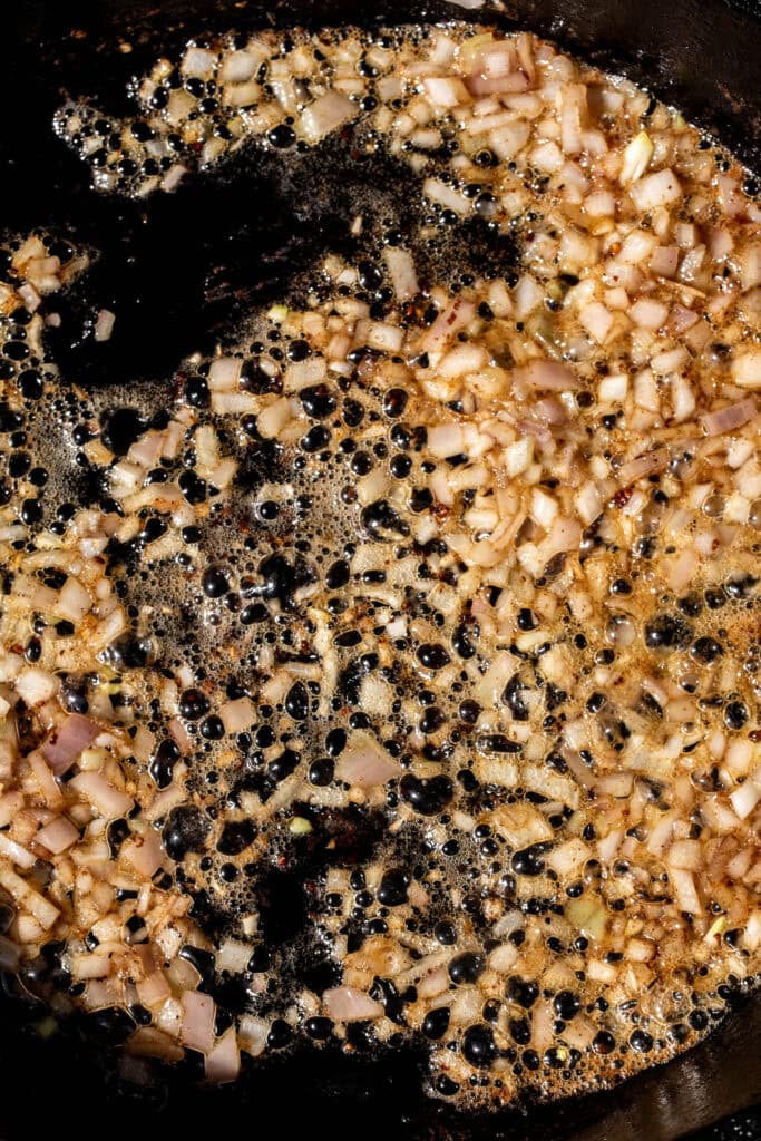 Diced onions cooking in hot pan with butter.