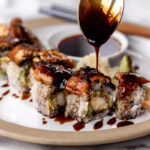 homemade eel sauce drizzled over a shrimp tempura and eel sushi roll.