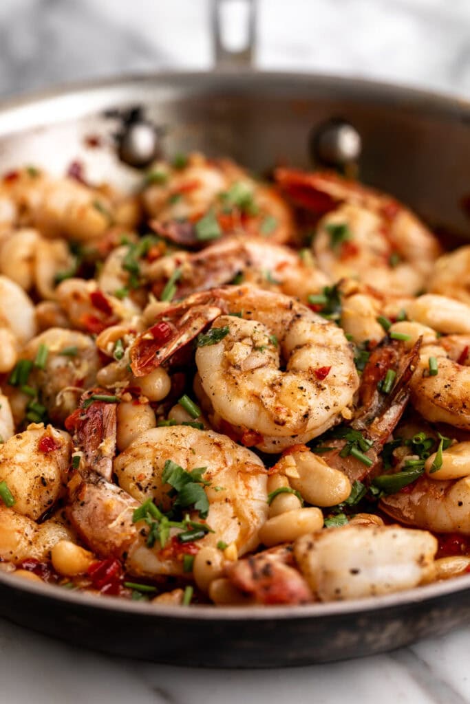 spicy shrimp and beans in pan.
