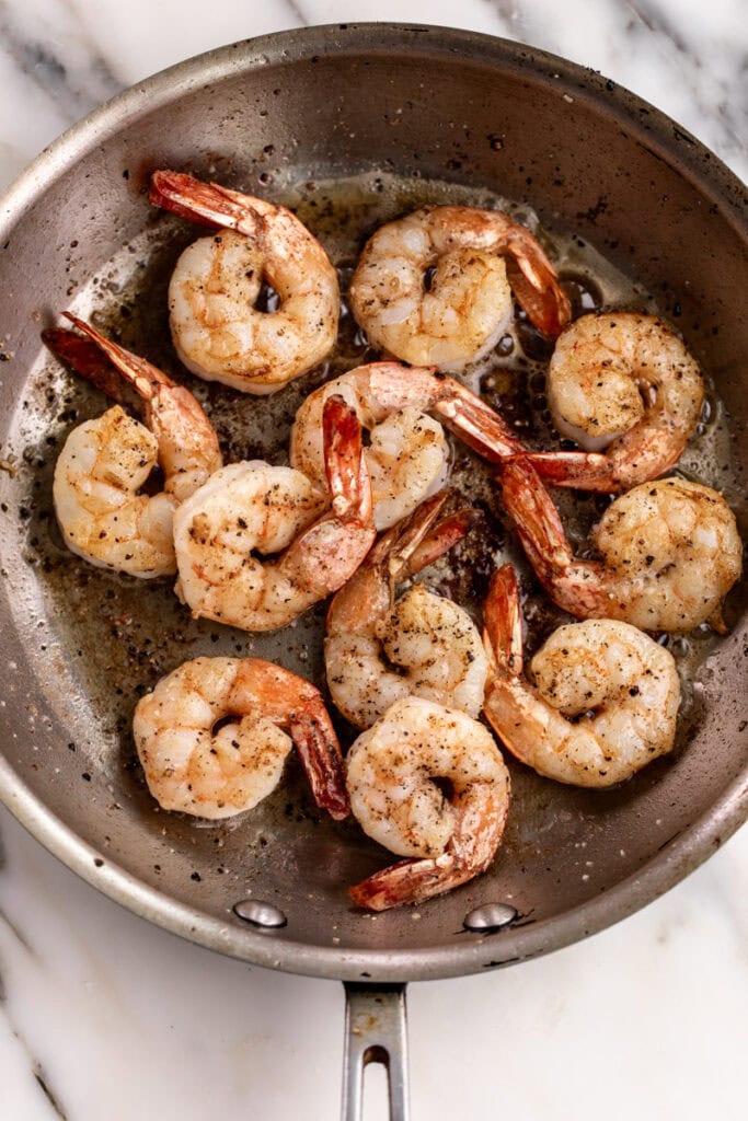 sautéed shrimp in pan cooked in butter.