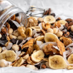 tropical trail mix with dried banana slices and coconut shavings.