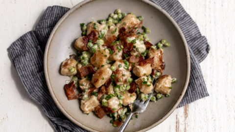 cauliflower gnocchi with bacon and easy Alfredo sauce and peas.