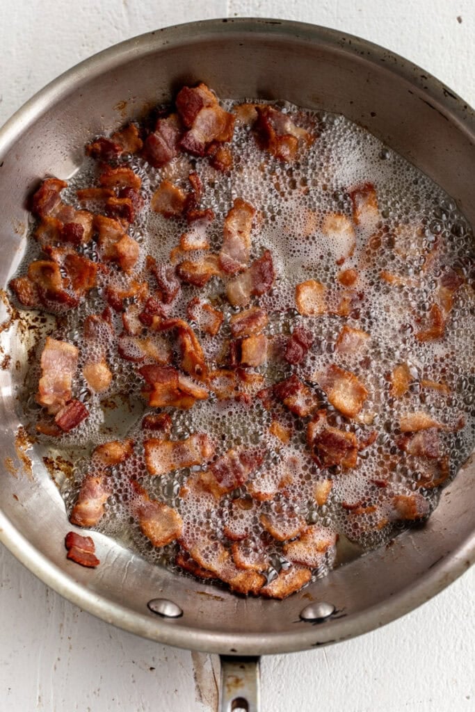 cooked diced bacon in pan.