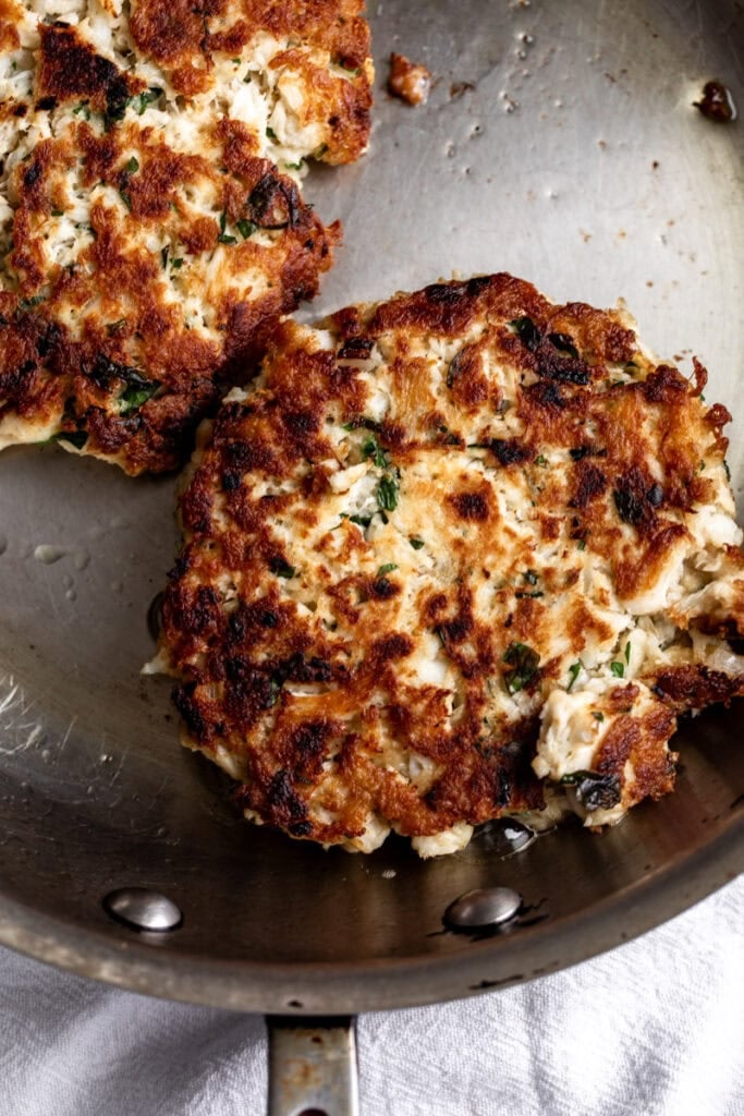 cooked crab cakes in pan for the sandwich.