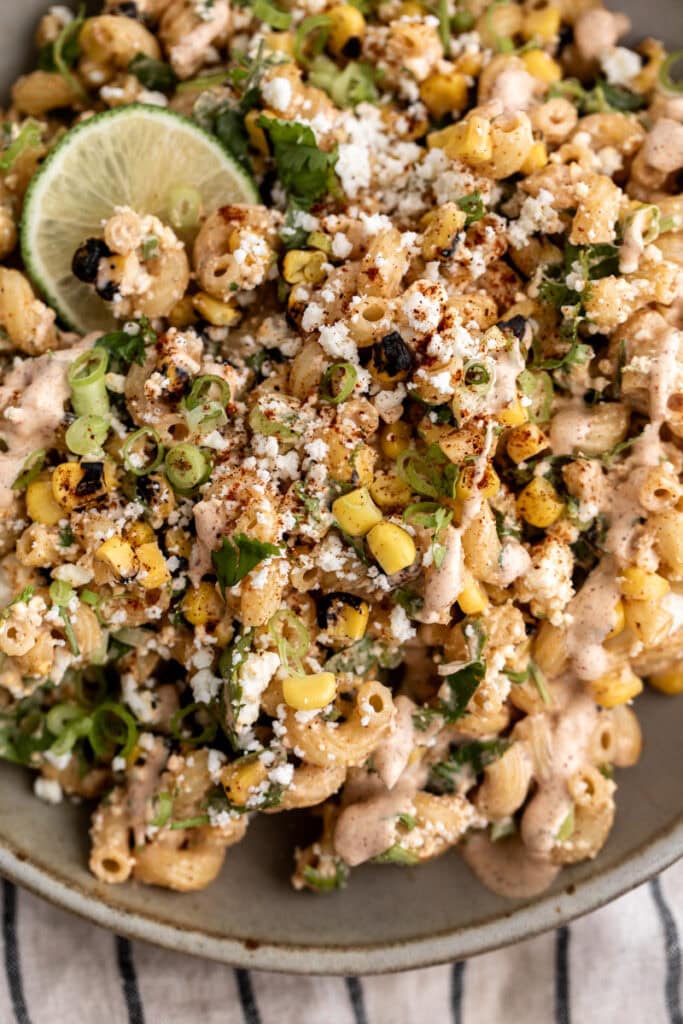 mexican street corn pasta salad esquites with lime wedge.