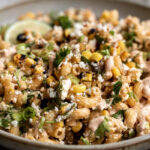 mexican street corn pasta salad esquites with lime wedge.