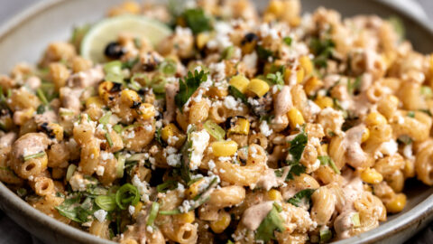 mexican street corn pasta salad esquites with lime wedge.