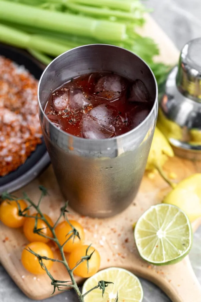mezcal bloody maria in cocktail shaker with ice.