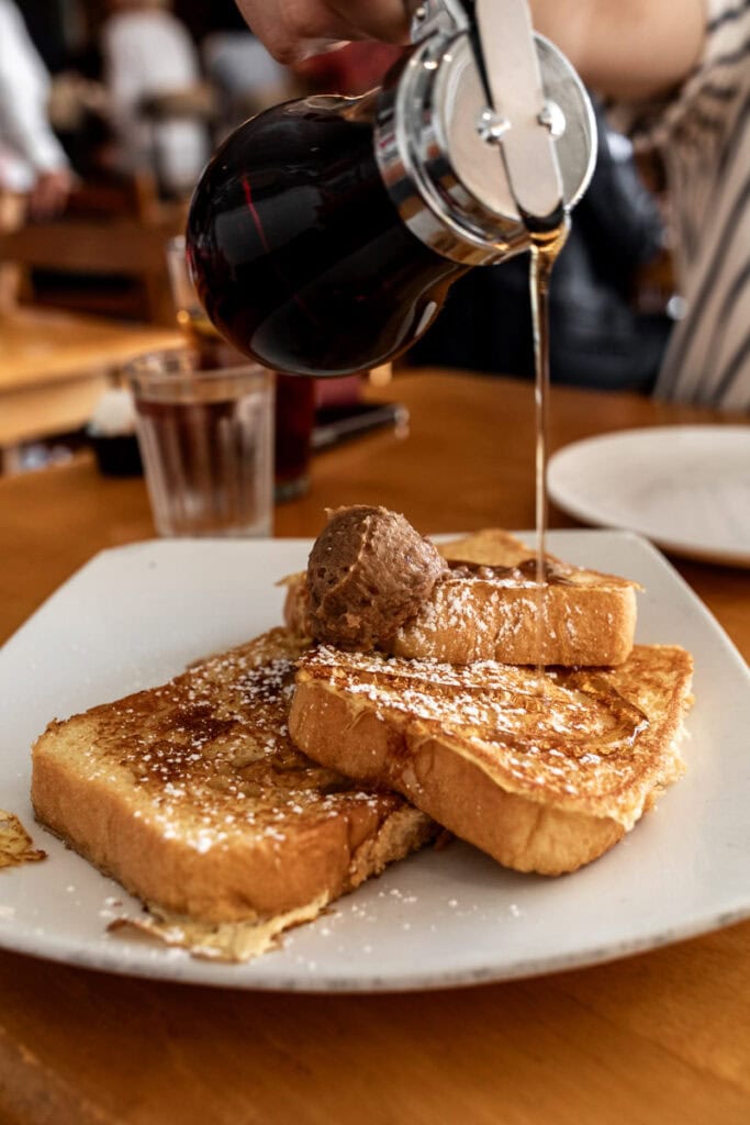 corner cafe french toast drizzled with maple syrup.