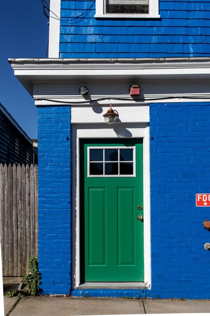 green door on blue building.