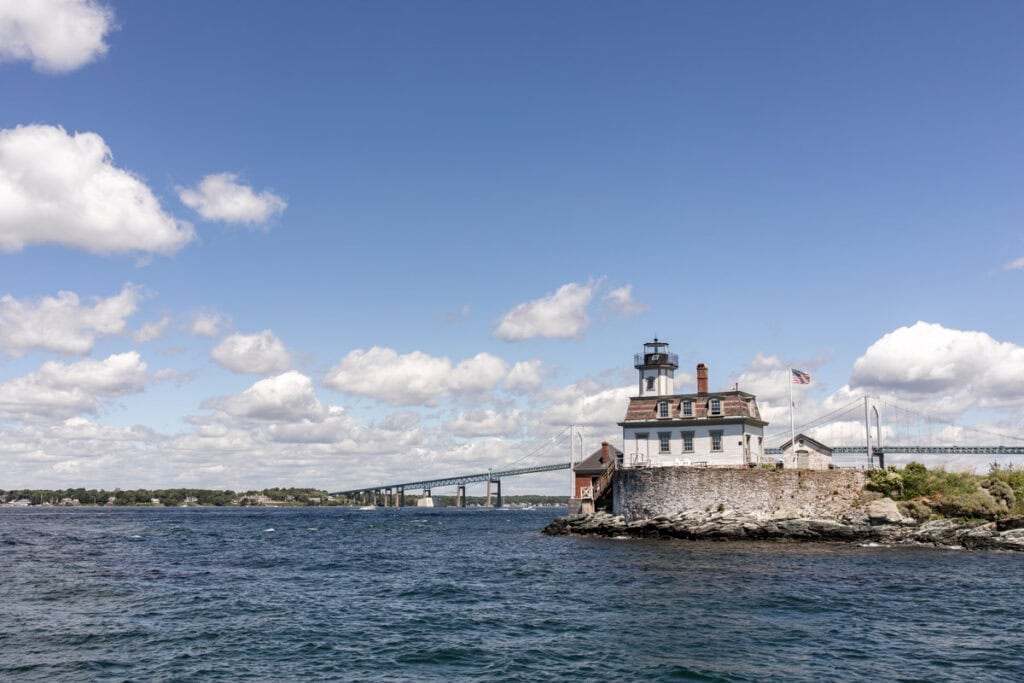 Newport rhode island lighthouse with bridge.
