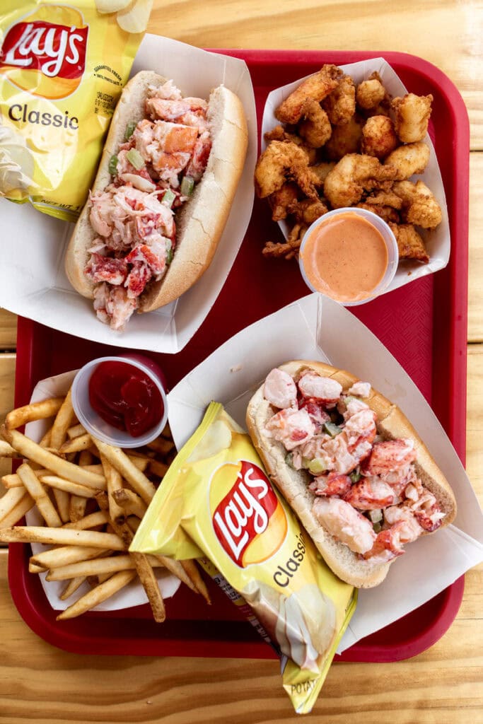 fresh lobster rolls with chips and french fries with battered fried lobster meat.