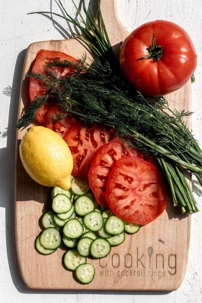 ingredients for Whitefish Salad Bagel Melt on wood cutting board.