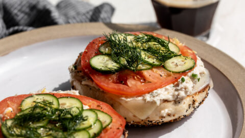 whitefish salad on everything bagel with tomato slice, cucumber and dill.