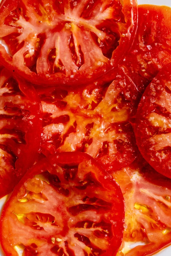marinated tomatoes in olive oil with flake salt.