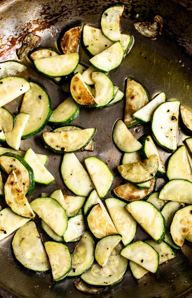 sautéed zucchini slices in sauté pan