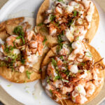 coconut shrimp ceviche tostadas with crispy fried shallots garnished with lime zest.