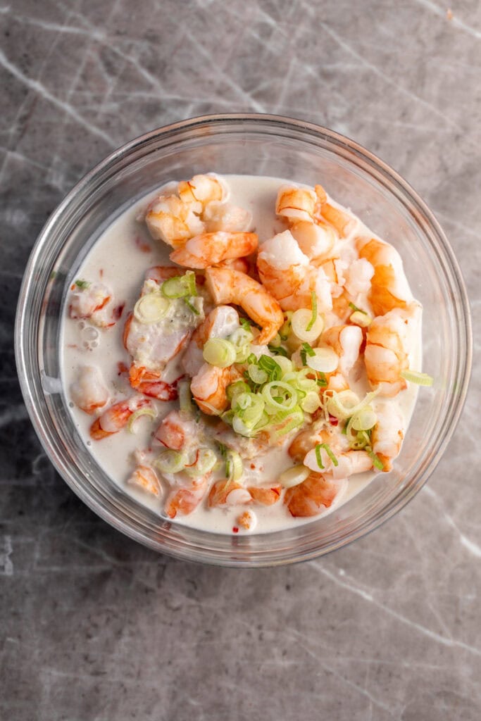 coconut shrimp mixture in glass mixing bowl.