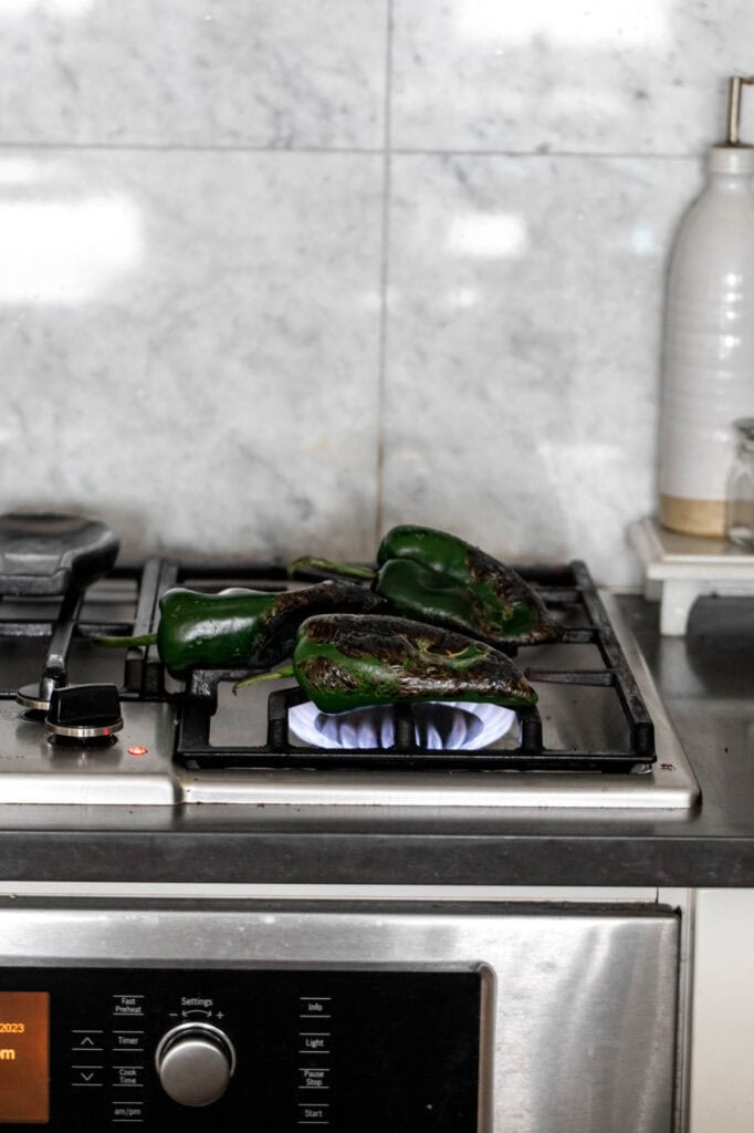 flame roasted poblano peppers on stove.