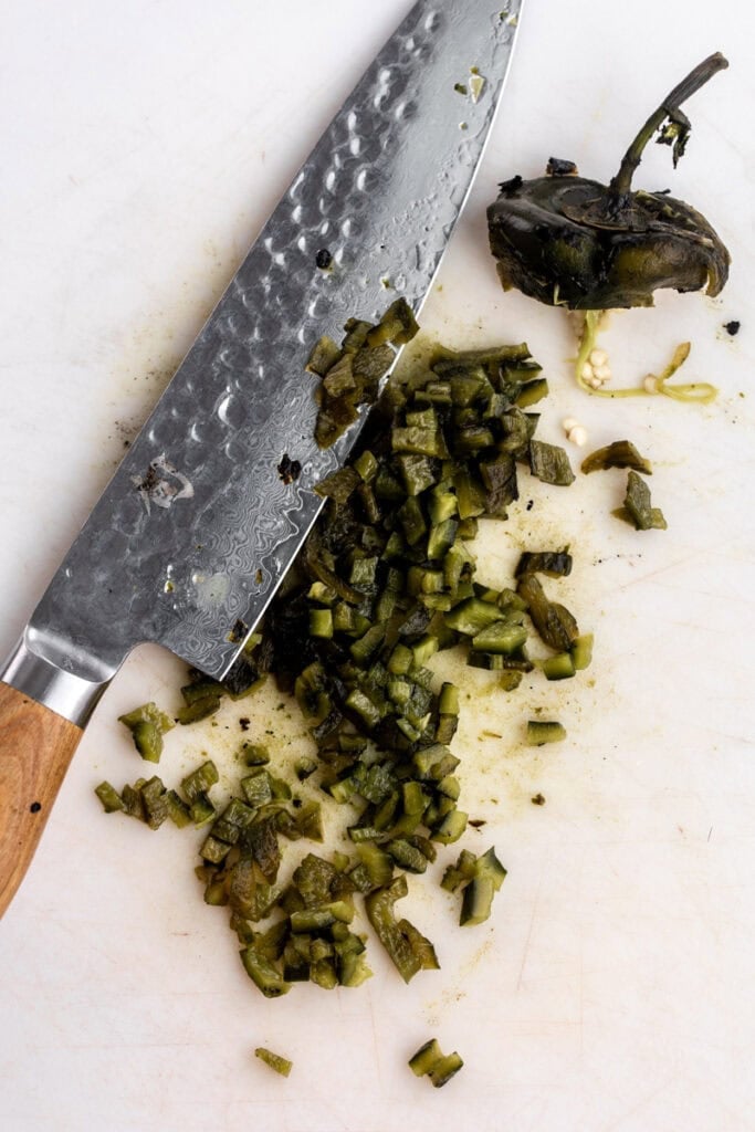 diced fire roasted poblano peppers with chef knife.
