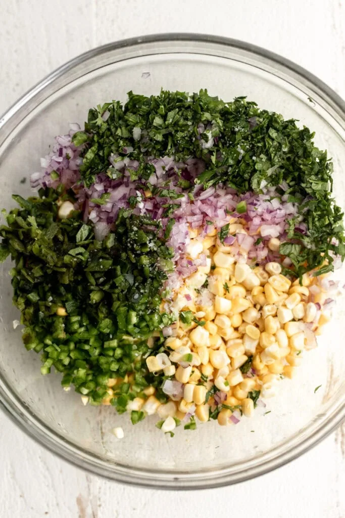 ingredients for fresh corn salsa in mixing bowl.