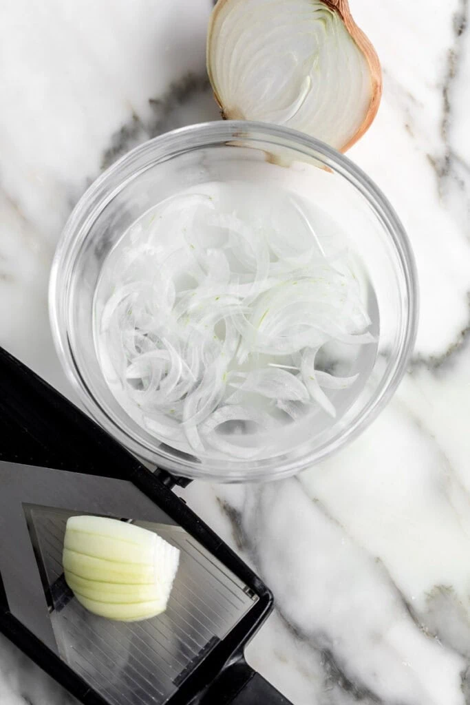 shaved onions soaking in water,