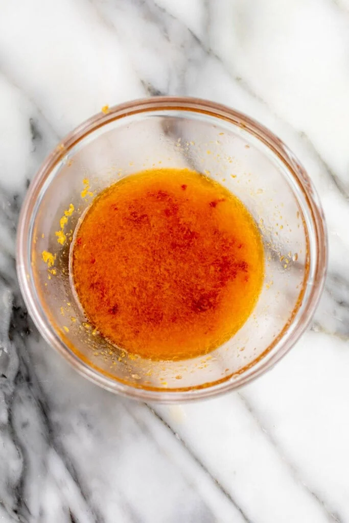 orange dressing in glass bowl.