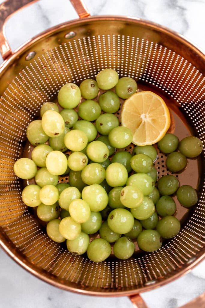 washed green grapes in strainer.