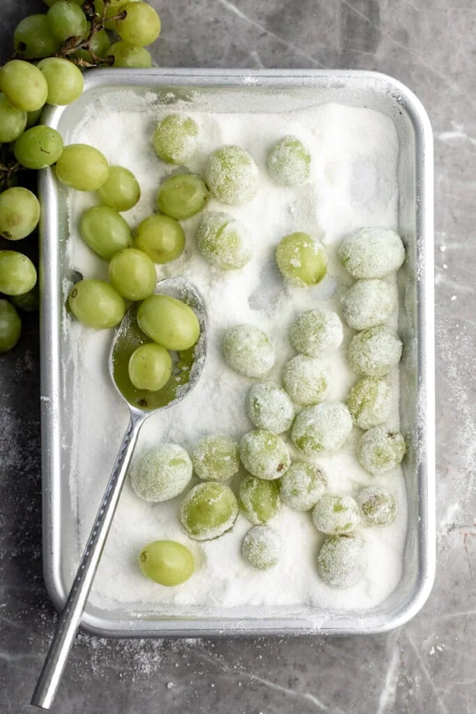green grapes tossed in sugar mixture on baking sheet