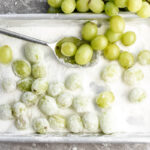 sour candied grapes on baking sheet in sugar.