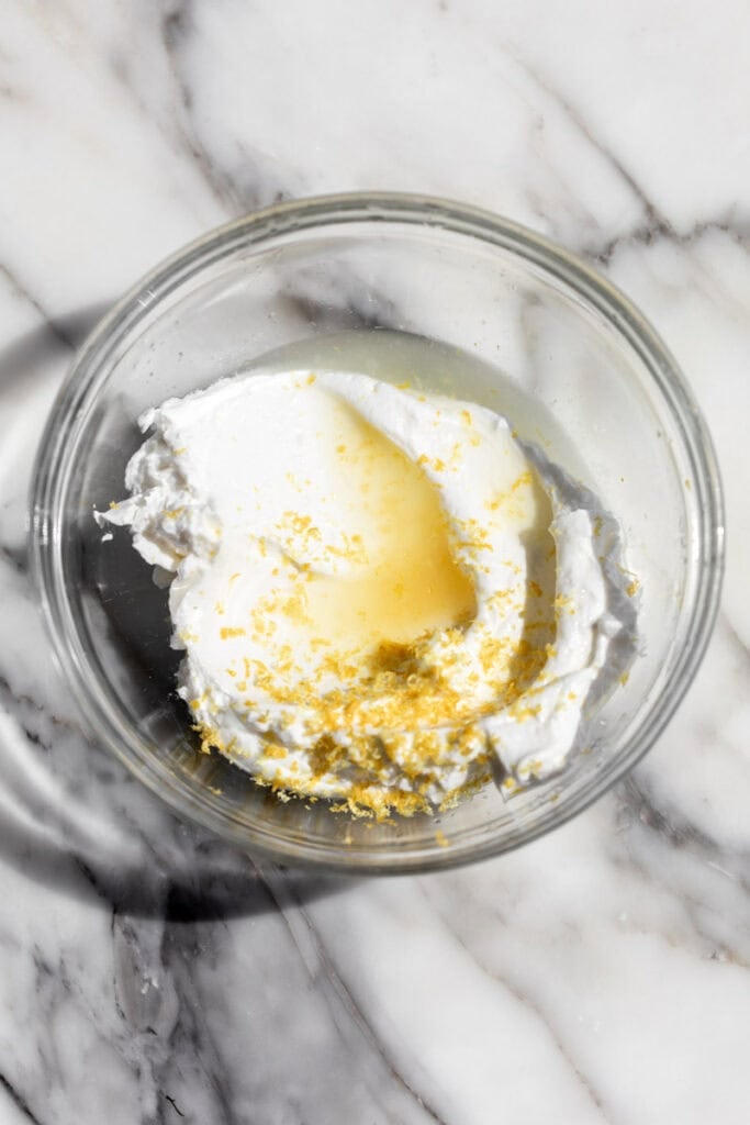 lemon yogurt sauce in glass mixing bowl.