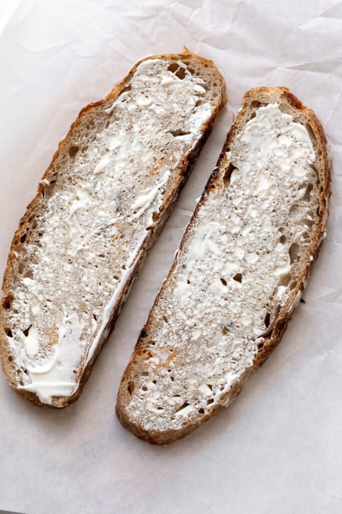 slices of sourdough bread slathered with mayonnaise.