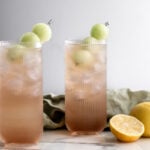 honey deuce cocktail with melon balls and halved lemons.