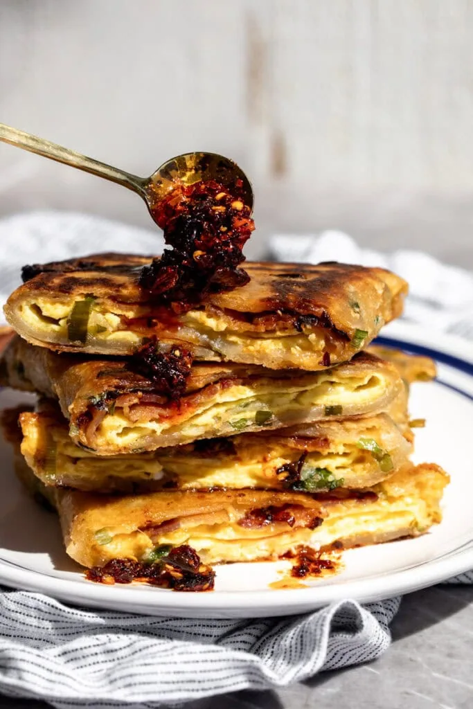 BEC scallion pancake breakfast sandwich with chili crisp.