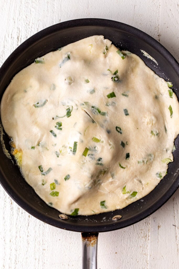 scallion pancake layered over eggs.