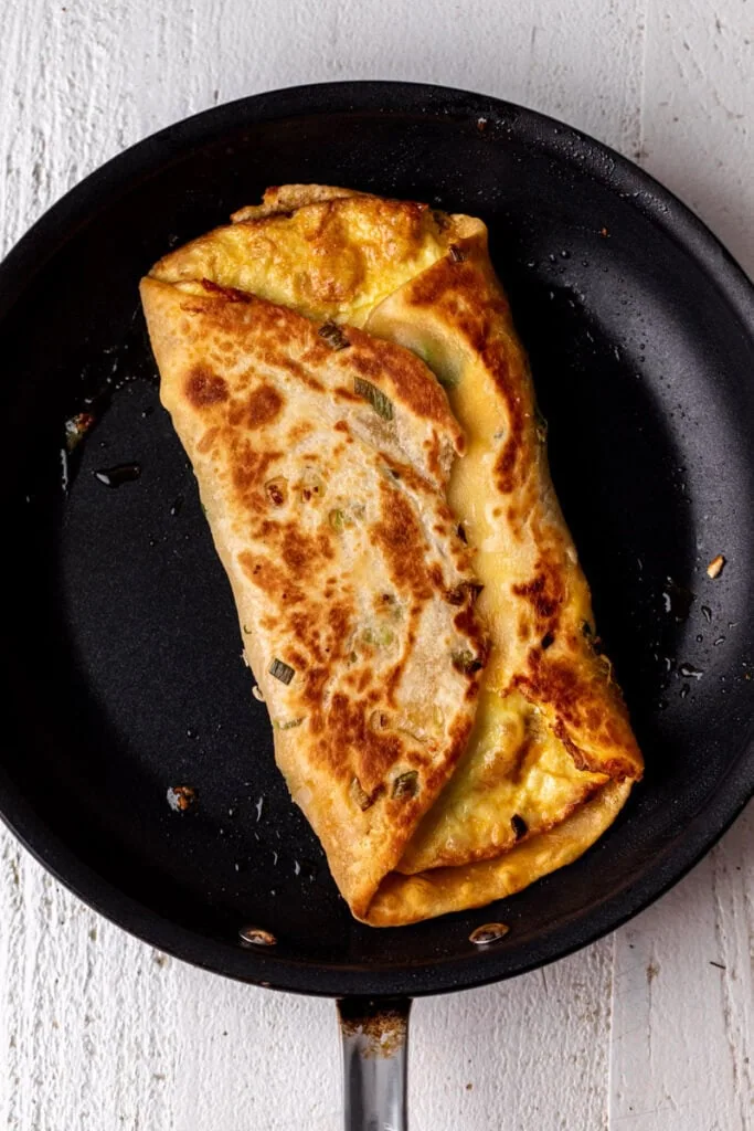 folded bacon egg and cheese in scallion pancake.