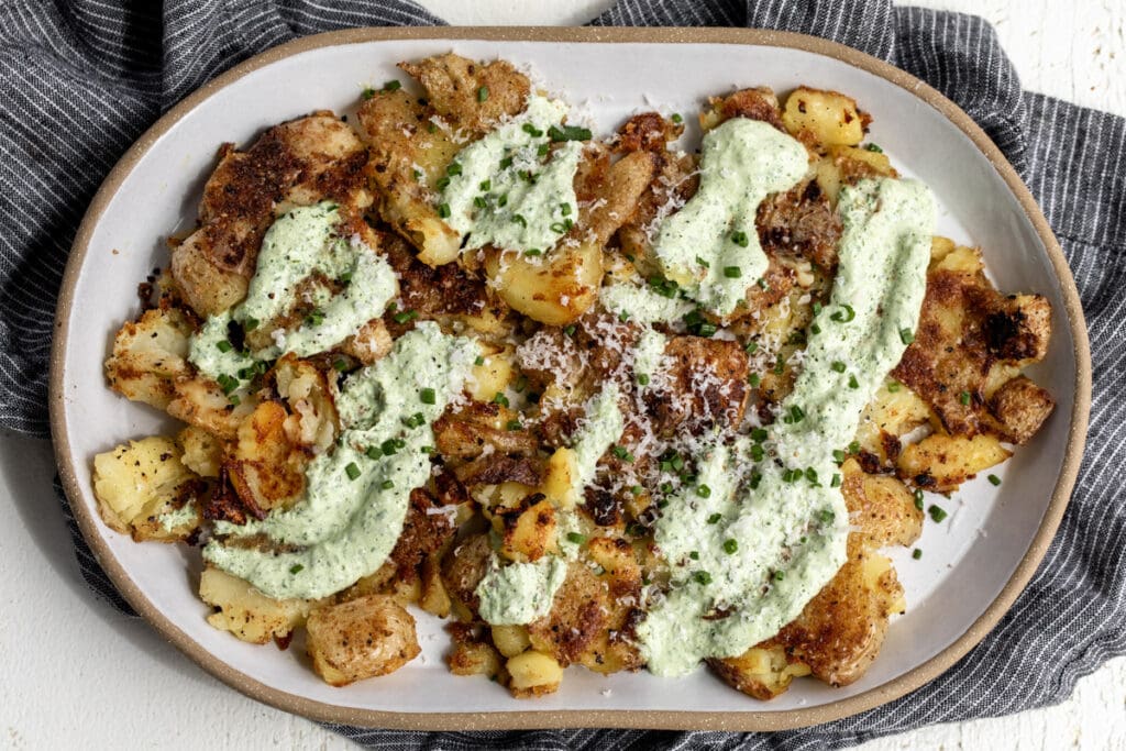 sour cream and onion smashed potatoes with herb sour cream, parmesan and diced chives.