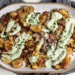 sour cream and onion smashed potatoes with herb sour cream, parmesan and diced chives.