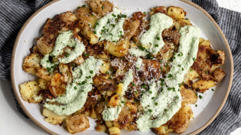 sour cream and onion smashed potatoes with herb sour cream, parmesan and diced chives.