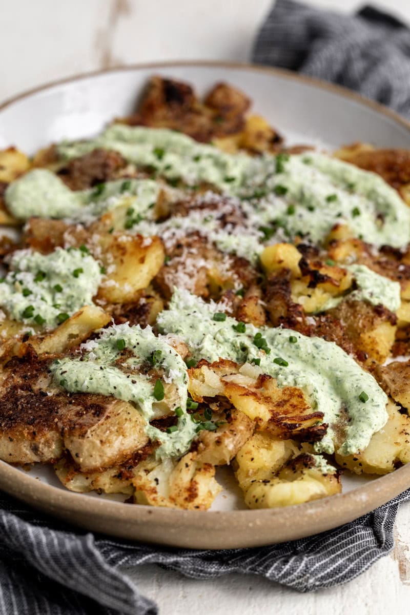 sour cream and onion smashed potatoes with herb sour cream, parmesan and diced chives.