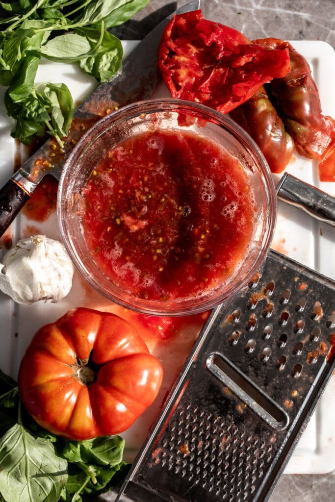 4-Ingredient No-Cook Easy Tomato Sauce grated in mixing bowl.