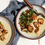 Green Curry Scallops with Corn topped with cilantro herb salad and fried crispy shallots.