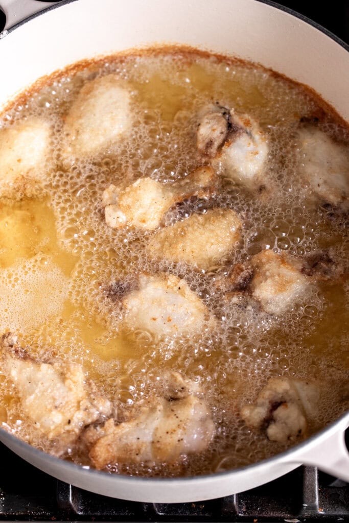 fried chicken wings in hot oil.