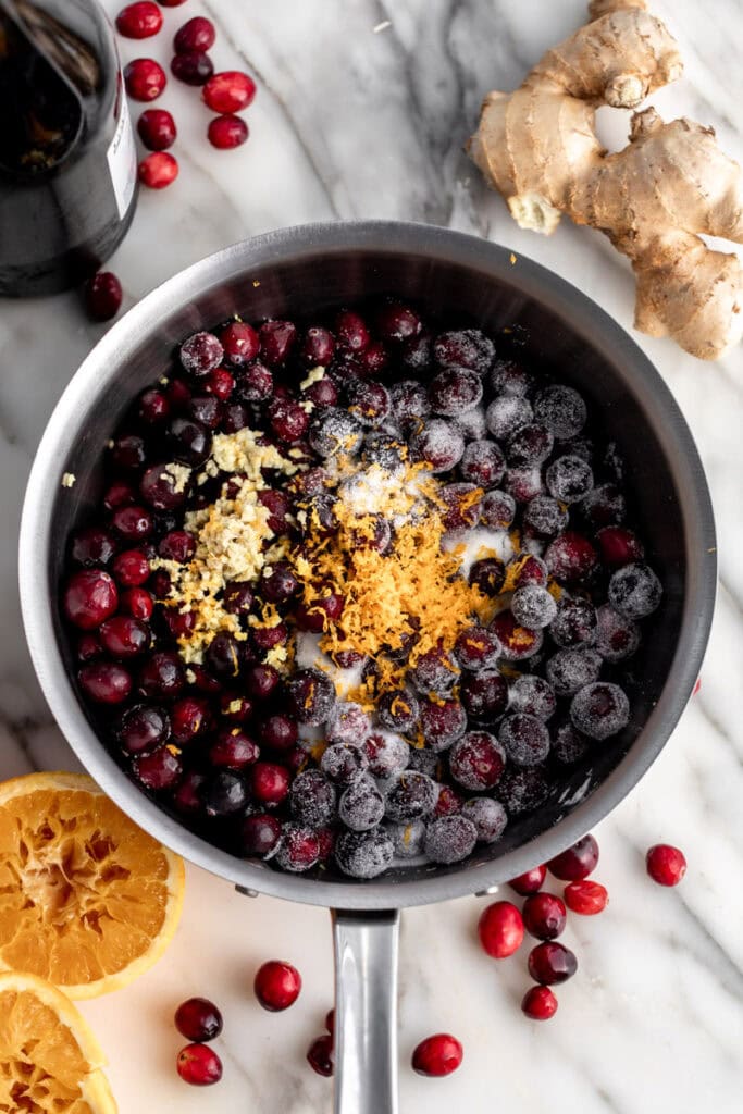 homemade cranberry sauce ingredients in saucepan.